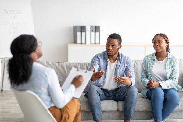 beautiful-black-couple-with-counselor-for-premarital-counseling-before-wedding