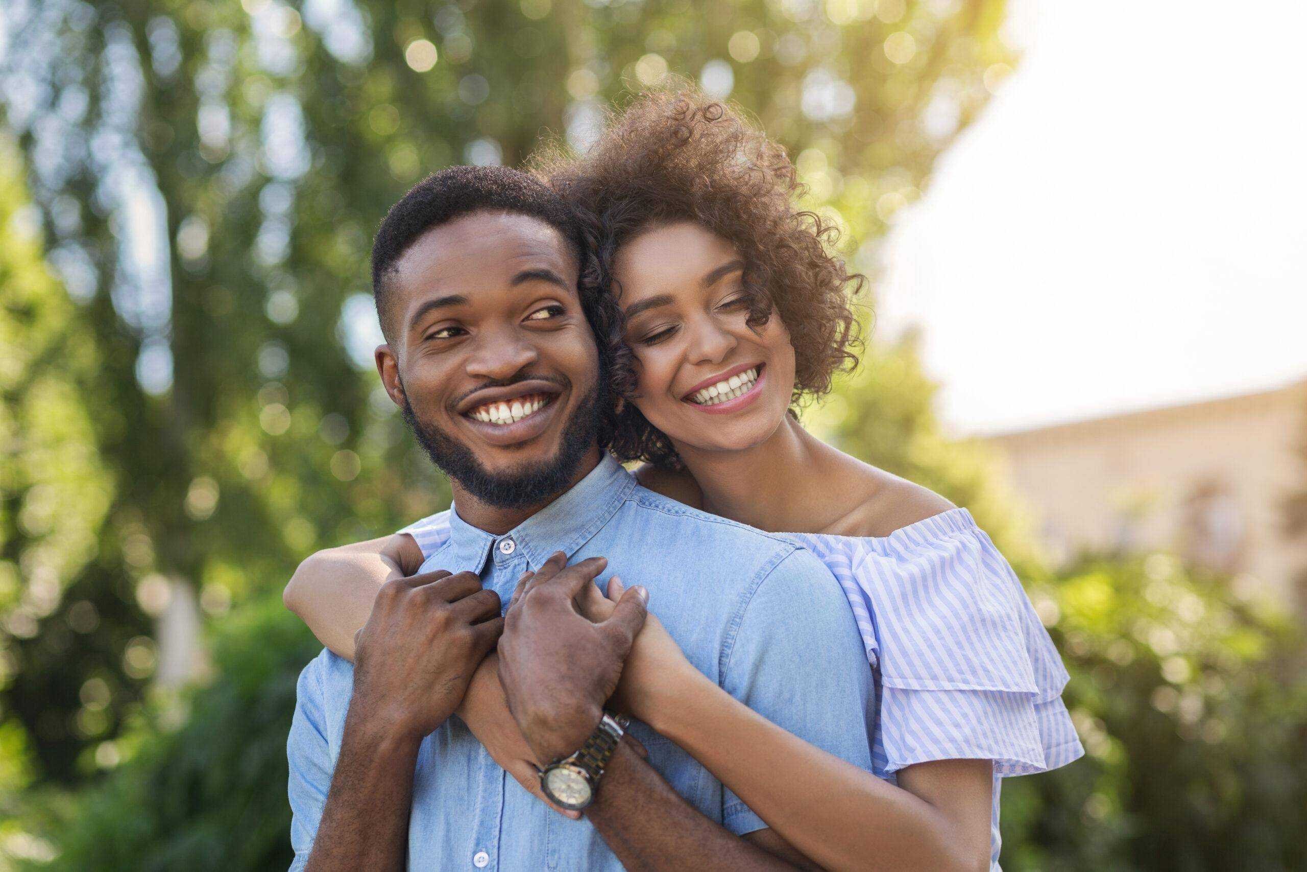African-american couple in love hugging in park