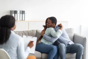 happy-black-couple-hugging-in-counselor-s-office
